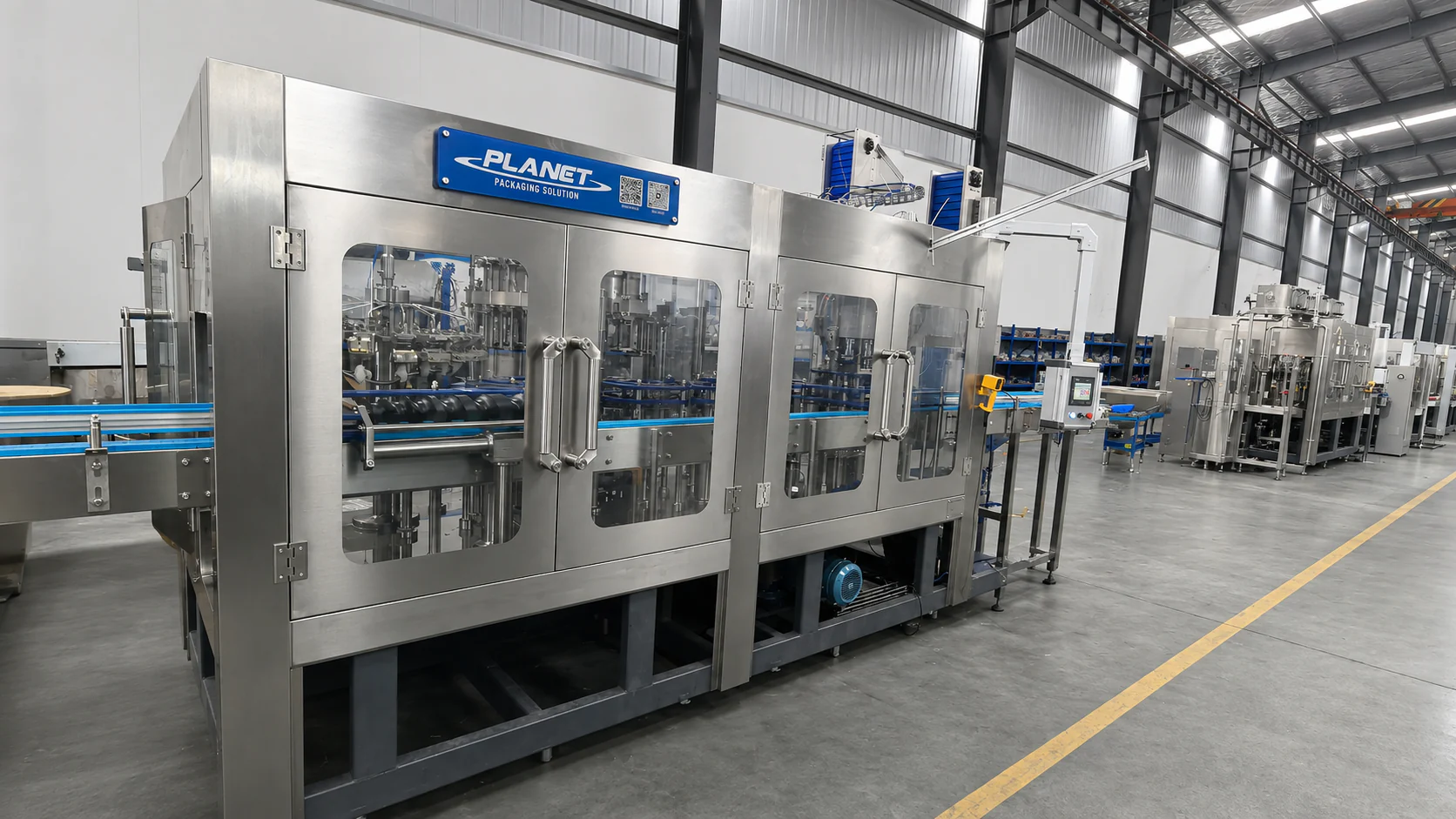 Planet stainless-steel glass-bottle filling and closing monoblock in an organized machinery assembly workshop