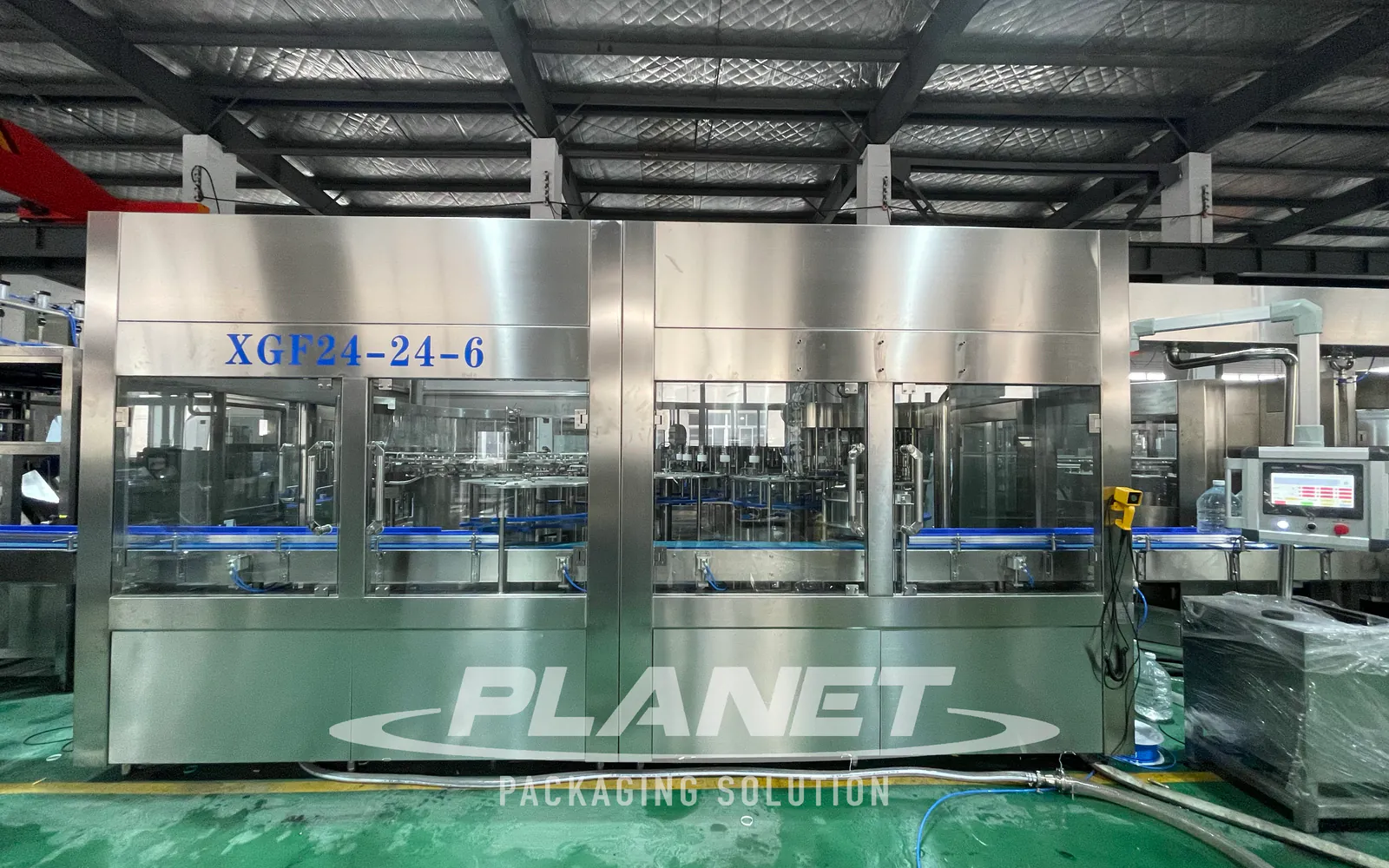 XGF large PET water bottle filling monoblock viewed from the front on the factory floor